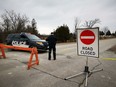 A special constable with the Kawartha Lakes Police Services stands at a road block in Kawartha Lakes, Ont., Friday, Nov. 27, 2020. Three Ontario Provincial Police officers were charged with manslaughter this week in the death of 18-month-old Jameson Shapiro after the shooting in Kawartha Lakes, Ont., nearly two years ago.THE CANADIAN PRESS/Doug Ives