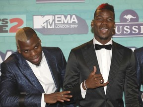 FILE - Soccer players Mathias Pogba, left, Paul Pogba pose for photographers upon arrival at the MTV European Music Awards 2017 in London, Sunday, Nov. 12, 2017. A police investigation into allegations that France soccer star Paul Pogba was targeted by extortionists took a bizarre new twist Friday Sept. 23, 2022 with the release by one of the suspects, his elder brother Mathias, of a long string of videos taking aim at the 2018 World Cup winner, his entourage and wealthy lifestyle.