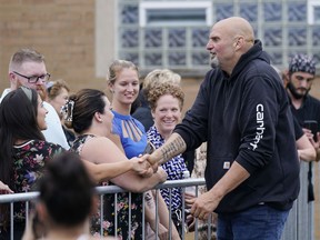Democratic Pa. Lt. Gov. John Fetterman greets people at a United Steelworkers of America Local Union 2227 event in West Mifflin, Pa., Monday, Sept. 5, 2022, that President Joe Biden also attended.