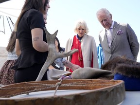 Prince Charles, right, and Camilla, Duchess of Cornwall, second from right, look at a display of traditional hunting tools and clothing after arriving in Yellowknife, Northwest Territories, during part of the Royal Tour of Canada, Thursday, May 19, 2022. Some Indigenous leaders and community members say they're concerned about making progress on reconciliation with King Charles III.