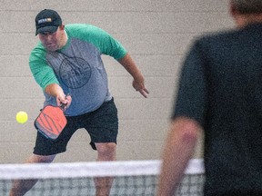 CEO Tim Reid takes part in one of the first games being played at Regina's Pickleball Hub at the REAL Campus on July 2021.