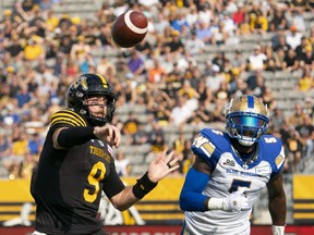 Hamilton Tiger Cats quarterback Dane Evans (9) throws under pressure from Winnipeg Blue Bombers defensive lineman Willie Jefferson (5) during first half CFL football game action in Hamilton, Ont. on Saturday, September 17, 2022.
