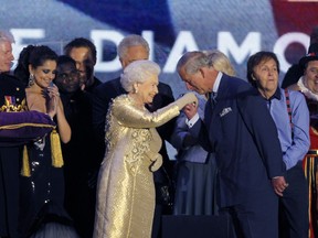 FILE - In this Monday, June 4, 2012 file photo, Prince Charles gestures to his mother, Britain's Queen Elizabeth II, at the end of the Queen's Jubilee Concert in front of Buckingham Palace, London. The concert is a part of four days of celebrations to mark the 60 year reign of Britain's Queen Elizabeth II. Queen Elizabeth II, Britain's longest-reigning monarch and a rock of stability across much of a turbulent century, has died. She was 96. Buckingham Palace made the announcement in a statement on Thursday Sept. 8, 2022.