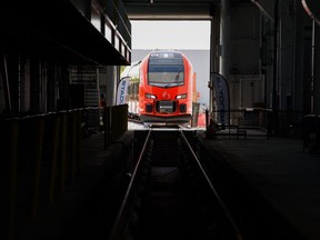A train approaches Walkley Yard during an unveiling event in Ottawa, Ont. on Friday, July 15, 2022. Ontario's financial watchdog says the effects of climate change are projected to cost the province an extra $1.5 billion a year on average in the next few years just to maintain public transportation infrastructure.