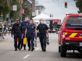Firefighters and paramedics leave after responding to a call where they could not locate a patient in the Downtown Eastside of Vancouver, on International Overdose Awareness Day on Tuesday, August 31, 2021. The coroners service in British Columbia says nearly 1,500 people have died this year from illicit drug use in the province.