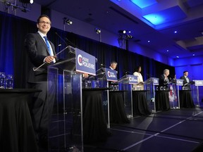 Conservative leadership hopeful Pierre Poilievre, left, smiles as he takes part in the Conservative Party of Canada French-language leadership debate in Laval, Quebec on Wednesday, May 25, 2022. The Conservative Party of Canada will announce its next leader in Ottawa tonight, after candidates and supporters spent the past seven months on its third leadership contest in six years.