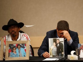 Mark Arcand, right, brother of James Smith Cree Nation stabbing victim Bonnie Burns, and Brian, husband of Bonnie, pause behind pictures of Bonnie during a news conference in Saskatoon, Saskatchewan, Canada on Sept. 7, 2022.