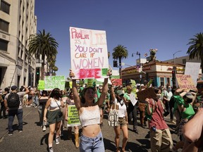 FILE - Abortion-rights activists rally on Hollywood Boulevard in Los Angeles, Saturday, July 9, 2022. Gov. Gavin Newsom signed more than a dozen new abortion laws on Tuesday, Sept. 27, 2022, including some that deliberately clash with restrictions in other states.