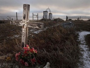 This Feb. 7, 2012 photo shows a cross on a grave at the Wounded Knee National Historic landmark in South Dakota. Two American Indian tribes in South Dakota have agreed to purchase 40 acres of land near the Wounded Knee National Historic Landmark on the Pine Ridge Indian Reservation.