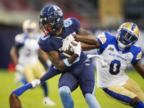 Toronto Argonauts' DaVaris Daniels (80) makes a reception as Winnipeg Blue Bombers' Les Maruo tries to defend during the first half of CFL football action in Toronto on July 4, 2022. The Blue Bombers and Argonauts can both secure home playoff games this weekend.