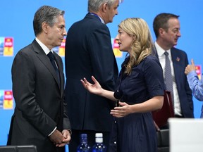U.S. Secretary of State Antony J. Blinken, left, speaks with Canadian Foreign Minister Melanie Joly during a round table meeting at a NATO summit in Madrid, Spain on June 29, 2022.