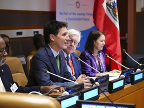 Prime Minister Justin Trudeau speaks as he sits with Canadian Ambassador to the United Nations Bob Rae at the United Nations during a meeting of the Ad Hoc Advisory Group and Caribbean partners on the situation in Haiti at the United Nations in New York on Wednesday, Sept. 21, 2022.