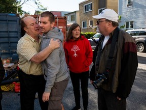 Protesters from The United People of Canada (TUPOC) organization, left, argues with a local resident, left, at the St. Brigid's church in the Lowertown neighbourhood of Ottawa, Friday, Sept. 23, 2022. A Superior Court Justice granted the application for the owners to evict TUPOC on Sept. 23 following a lengthy court challenge. TUPOC director William Komer is seen second from left.