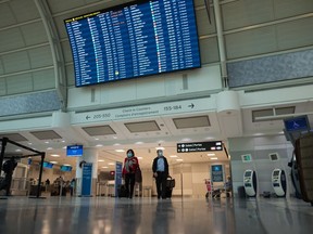 Travelers are photographed at Toronto Pearson International Airport, on Thursday, December 16, 2021. New Air Passenger Protection Regulations go into effect this week.