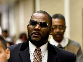 FILE - Musician R. Kelly, center, leaves the Daley Center after a hearing in his child support case on May 8, 2019, in Chicago. Closing arguments are scheduled Monday, Sept. 12, 2022 for R. Kelly and two co-defendants in the R&B singer's trial on federal charges of trial-fixing, child pornography and enticing minors for sex, with jury deliberations to follow.