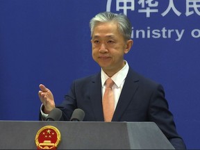 FILE - Chinese Foreign Ministry spokesperson Wang Wenbin reacts during the daily presser at the Ministry of Foreign Affiairs in Beijing, on May 27, 2022. After a U.N. report concluding that China's crackdown in the far west Xinjiang region may constitute crimes against humanity, China used a well-worn tactic to deflect criticism: blame a Western conspiracy.