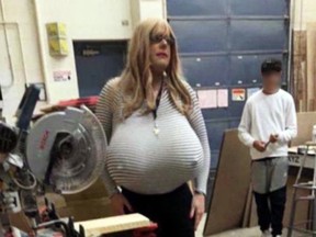 An image from a video taken at Ontario’s Oakville Trafalgar High School showing a shop teacher wearing enormous silicone breasts with visible nipples while teaching class.