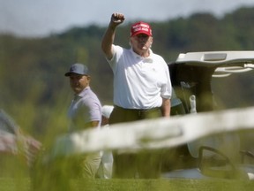 Former President Donald Trump gestures while playing golf at Trump National Golf Club in Sterling, Va., Tuesday, Sept. 13, 2022.