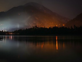 The Flood Falls Trail wildfire burns above the Fraser River in Hope, B.C., Monday, Sept. 12, 2022.