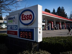 A sign displays the price of a litre of regular grade gasoline at an Esso gas station in Vancouver, on Tuesday, March 8, 2022. The final long weekend of summer will also be the cheapest for Canadian drivers, with gasoline prices heading into the Labour Day holiday the lowest they've been since late February.