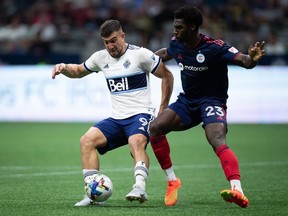 Vancouver Whitecaps' Lucas Cavallini (9) and Chicago Fire's Carlos Teran (23) vie for the ball during the second half of an MLS soccer game in Vancouver, on Saturday, July 23, 2022.&ampnbsp;The Vancouver Whitecaps will be without their leading scorer for the rest of September after Major League Soccer's disciplinary committee handed Cavallini a four-game suspension Thursday.