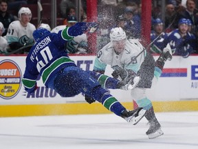 Vancouver Canucks' Elias Petterson (40), of Sweden, and Seattle Kraken's Ryan Donato (9) collide during overtime NHL hockey acton in Vancouver, on Thursday, September 29, 2022.