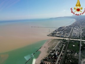 This picture released by the Italian firefighters shows an aerial view of the Senigallia coast after floods hit Marche region, central-east Italy, Friday, Sept. 16, 2022. Floodwaters triggered by heavy rainfall swept through several towns in the hilly region of Marche, central-east Italy early Friday, leaving 10 people dead and several missing, state radio said. Dozens of survivors scrambled onto rooftops or up trees to await rescue. (Italian Firefighters - Vigili del Fuoco via AP)