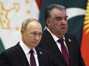 Russian President Vladimir Putin, left, and Tajikistan's President Emomali Rahmon arrive to attend the Shanghai Cooperation Organization (SCO) summit in Samarkand, Uzbekistan, Friday, Sept. 16, 2022.