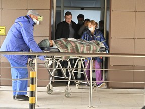 Medical staff carry an injured person on a stretcher at the emergency department of the First Republican Clinical hospital to evacuate to Moscow, in Izhevsk, Russia, Tuesday, Sept. 27, 2022. The plane of the Ministry of Emergency Situations will deliver victims of the shooting at school No. 88 in Izhevsk to Moscow hospitals. This was stated by the Presidential Commissioner for Children's Rights Maria Lvova-Belova. According to officials, 11 children were among those killed in the Monday morning shooting in School No. 88 in Izhevsk, a city 960 kilometers (600 miles) east of Moscow.