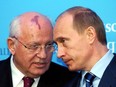 Russia's President Vladimir Putin, right, talks with former Soviet President Mikhail Gorbachev at the start of a news conference at the Castle of Gottorf in Schleswig, northern Germany, Tuesday, Dec. 21, 2004.