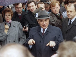 FILE - Soviet President Mikhail S. Gorbachev, his wife Raisa at his side holding an umbrella speak to the media at an polling station in Moscow on March, 26, 1989. When Gorbachev came to power as Soviet leader in 1985, he was younger and more vibrant than his predecessors. He dramatically broke with the Communist past by moving away from a police state, embracing freedom of the press, ending his country's war in Afghanistan and letting go of Eastern European countries that had been locked in Moscow's grip for decades..
