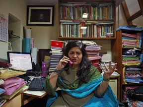 FILE- Rights activist Teesta Setalvad speaks on phone during an interview with The Associated Press at her office in Mumbai, India, Sept. 7, 2015. India's top court has granted bail to the activist who has spearheaded a campaign to hold officials responsible for the deadly 2002 anti-Muslim riots in western Gujarat state. Setalvad was granted bail Friday, Sept. 2, 2022, more than two months after she was detained on allegations of fabricating evidence against officials, including Prime Minister Narendra Modi who was the state's top elected official at the time of the riots.