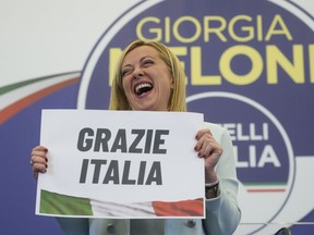 Far-Right party Brothers of Italy's leader Giorgia Meloni shows a placard reading in Italian "Thank you Italy" at her party's electoral headquarters in Rome, Sunday, Sept. 25, 2022. Italians voted in a national election that might yield the nation's first government led by the far right since the end of World War II.