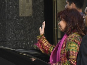 Argentine Vice President Cristina Fernandez waves to supporters as she exits her home four days after a person pointed a gun at her here in the Recoleta neighborhood of Buenos Aires, Argentina, Monday, Sept. 5, 2022.