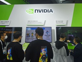 Visitors stop by the booth of Nvidia at the Apsara Conference, an annual cloud service technology forum hosted by Alibaba Group, in Hangzhou in eastern China's Zhejiang province Tuesday, Oct. 19, 2021. The Chinese government on Thursday, Sept. 1, 2022, called on Washington to repeal its technology export curbs after chip designer Nvidia Corp. said a new product might be delayed and some work might be moved out of China. (Chinatopix Via AP)
