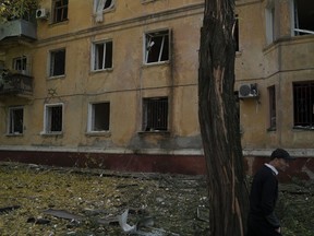 A man walks past a damaged building after a Russian attack in Kramatorsk, Ukraine, Thursday, Sept. 29, 2022.