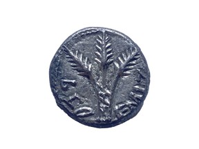 This undated photo, taken in New York, shows a rare, 2,000-year-old Jewish coin that U.S. authorities have returned to Israel nearly two decades after it was looted, smuggled and put up for auction in the United States. The quarter shekel silver coin, minted in the year 69, is believed to be one of just two confirmed to exist. (Israel's Antiquities Authority via AP)