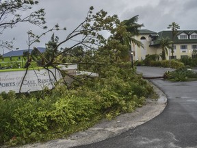Fallen trees lay over the Ports of Call Resort entrance after the passage of Hurricane Fiona in Providenciales, Turks and Caicos Islands, Tuesday, Sept. 20, 2022.