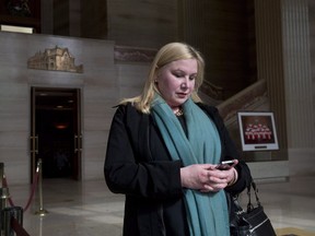 Wendy Cukier reads a message on her smartphone as she stands in the foyer of the Supreme Court of Canada in Ottawa, Friday, March 27, 2015. An umbrella group of gun-control advocates says any exceptions to the federal handgun freeze should be very narrowly defined.