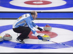 Quebec skip Jean-Michel Menard directs the sweep as they play British Columbia in draw 9 action at the Tim Hortons Brier curling championship at Mile One Centre in St. John's on Tuesday, March 7, 2017.