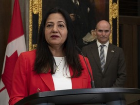 Minister of Health Jean-Yves Duclos looks on as Sonia Sidhu, MP for Brampton South, speaks during an announcement in the foyer of the House of Commons on Parliament Hill, Wednesday, October 5, 2022 in Ottawa.