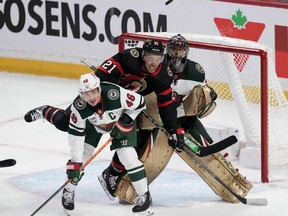 Minnesota Wild defenceman Jared Spurgeon keeps his eye on the puck as he ties up Ottawa Senators right wing Mathieu Joseph in front of goaltender Marc-Andre Fleury during second period NHL action, Thursday, October 27, 2022 in Ottawa.