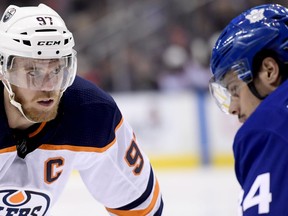 Edmonton Oilers centre Connor McDavid (97) takes a faceoff against Toronto Maple Leafs centre Auston Matthews (34) during first period NHL action in Toronto, Wednesday, Feb. 27, 2019.