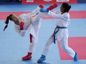Luis Fernanda, left, of Guatemala, and Wendy Mosquera, of Colombia, compete in the women's kumite 68kg karate elimination round at the Bolivarian Games in Valledupar, Colombia, Sunday, June 26, 2022.&ampnbsp;Plans for the Quebec Cup were postponed Thursday due to "confusion in the interpretation and application of the Criminal Code" that makes karate competitions illegal without a provincial decree, Karate Quebec said Thursday.