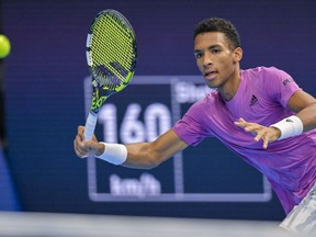 Canada's Felix Auger-Aliassime returns a ball to Switzerland's Marc-Andrea Huesler during their first round match at the Swiss Indoors tennis tournament at the St. Jakobshalle in Basel, Switzerland, Wednesday, Oct. 26, 2022.