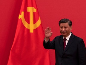 OCTOBER 23: General Secretary and Chinese President Xi Jinping waves as he leaves after speaking at a press event with Members of the new Standing Committee of the Political Bureau of the Communist Party of China and Chinese and Foreign journalists at The Great Hall of People on October 23, 2022 in Beijing, China.
