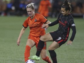 Portland Thorns forward Sophia Smith, right, and Houston Dash midfielder Sophie Schmidt, left, compete for the ball during the second half of an NWSL soccer match in Portland, Ore., Wednesday, Oct. 6, 2021. The Houston Dash have signed Canadian internationals Sophie Schmidt and Allysha Chapman to contract extensions.