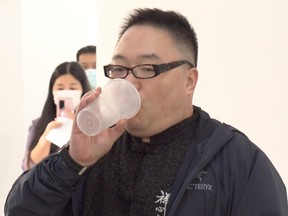 In this photo taken from video released by Shanghai Media Group, a man inhale aerosolised COVID vaccine developed by Chinese biopharmaceutical company CanSino Biologics Inc. in Shanghai on Wednesday, Oct. 26, 2022. The Chinese city of Shanghai started administering the inhalable COVID-19 vaccine on Wednesday in what appears to be a world first.