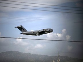 A Canadian Air Force plane takes off after unloading equipment for Haitian police at the airport in Port-au-Prince, Haiti, Saturday, Oct. 15, 2022.