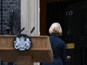 Britain's Prime Minister Liz Truss comes back inside 10 Downing Street, in central London, on October 20, 2022 following a statement to announce her resignation. (Photo by Daniel LEAL / AFP)